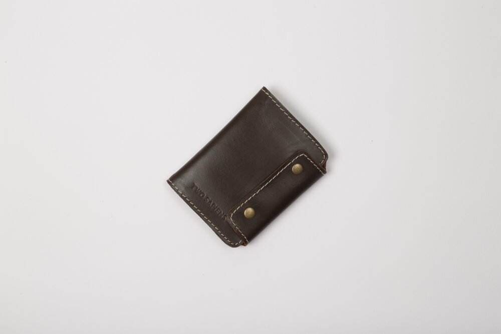 Chestnut brown leather snap-button card holder wallet closed, embossed with Two Sapiens logo