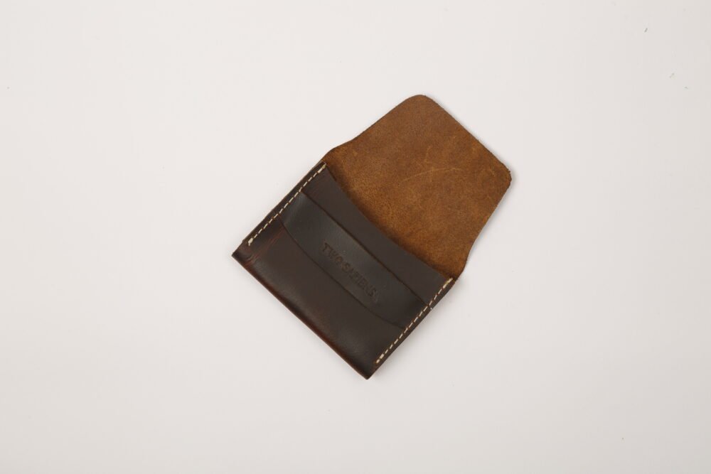 Dark brown leather card wallet closed on white background – Two Sapiens branding embossed